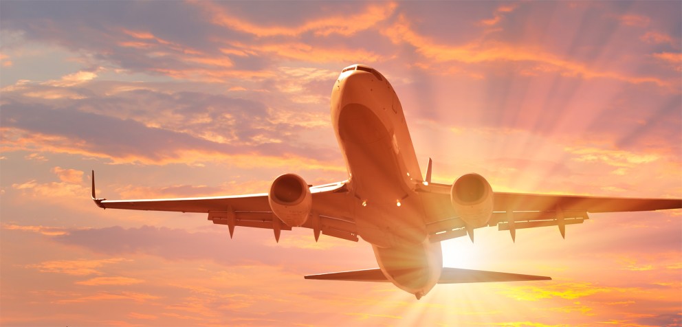 airplane taking off agains the sunset